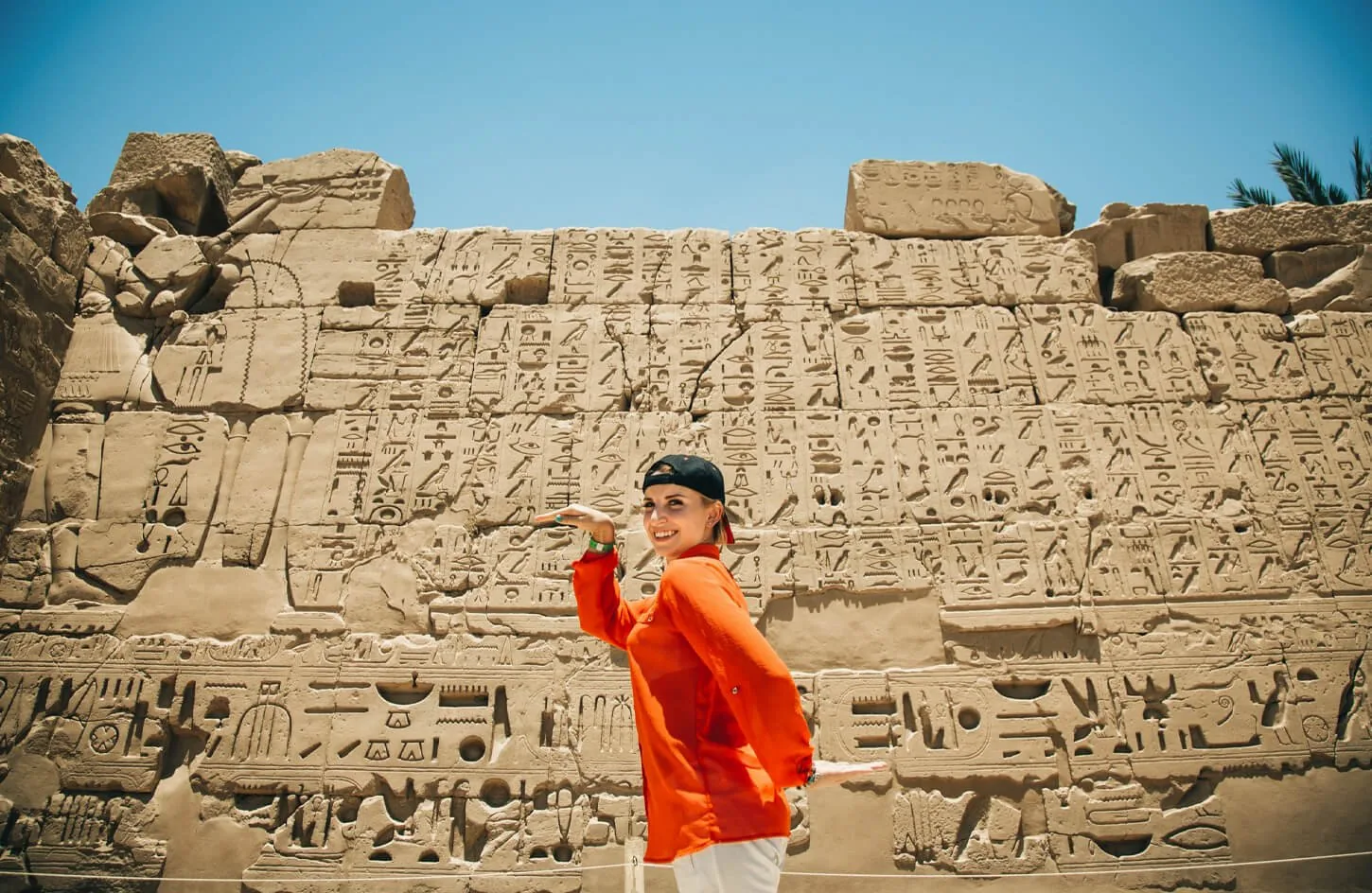 traveler exploring ancient temple columns in luxor before relaxing on red sea beaches during a 9 day egypt package