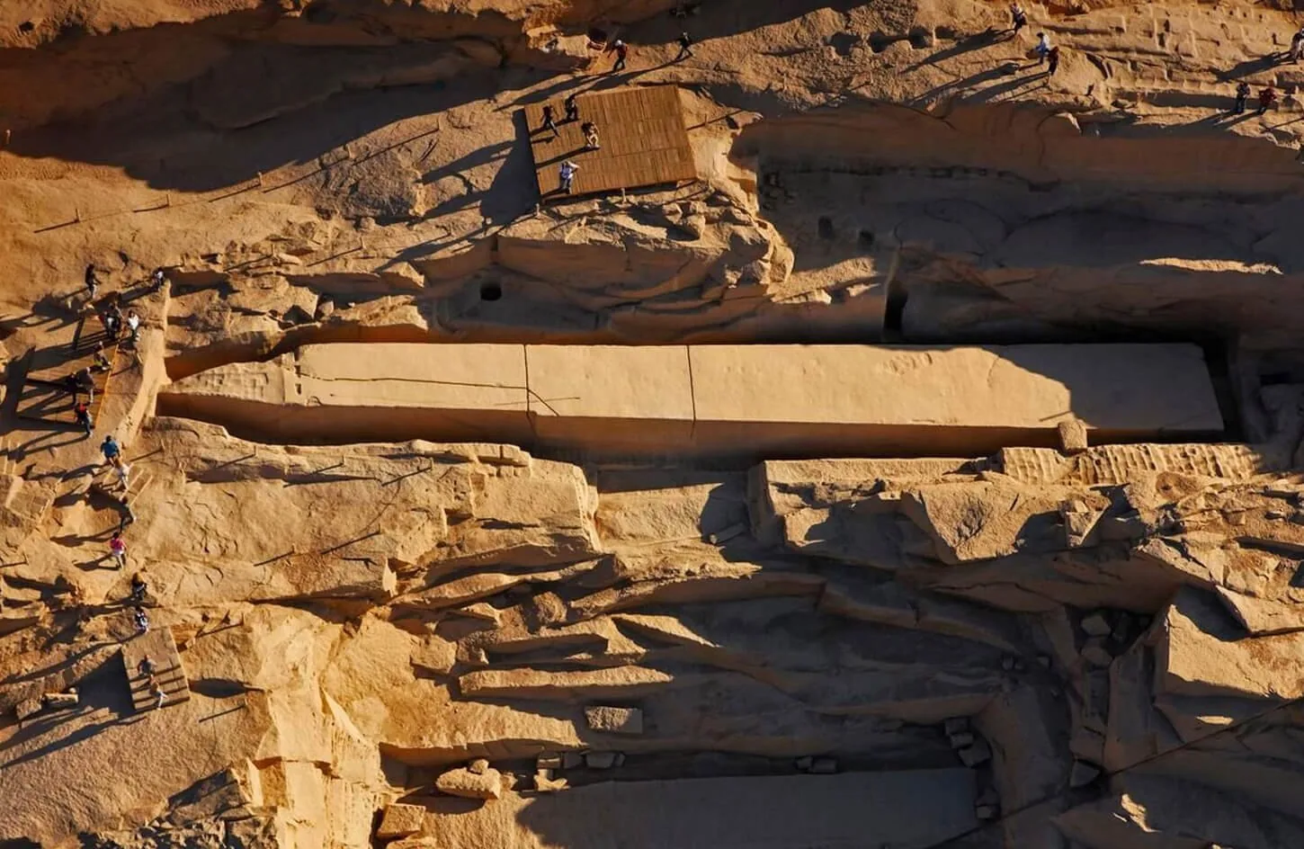 massive carved pink granite unfinished obelisk resting in an ancient pharaonic stone quarry in aswan