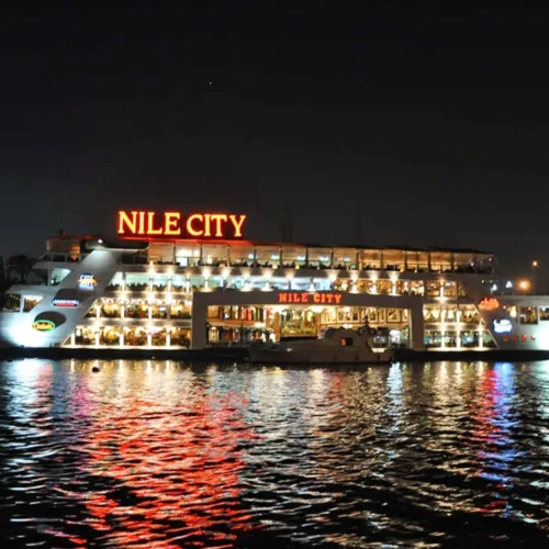illuminated floating restaurant cruise ship sailing along the river nile in cairo at night during a dinner cruise