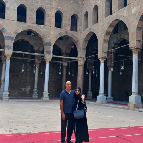Two Travelers in the columned courtyard of a Mamluk-era Cairo mosque
