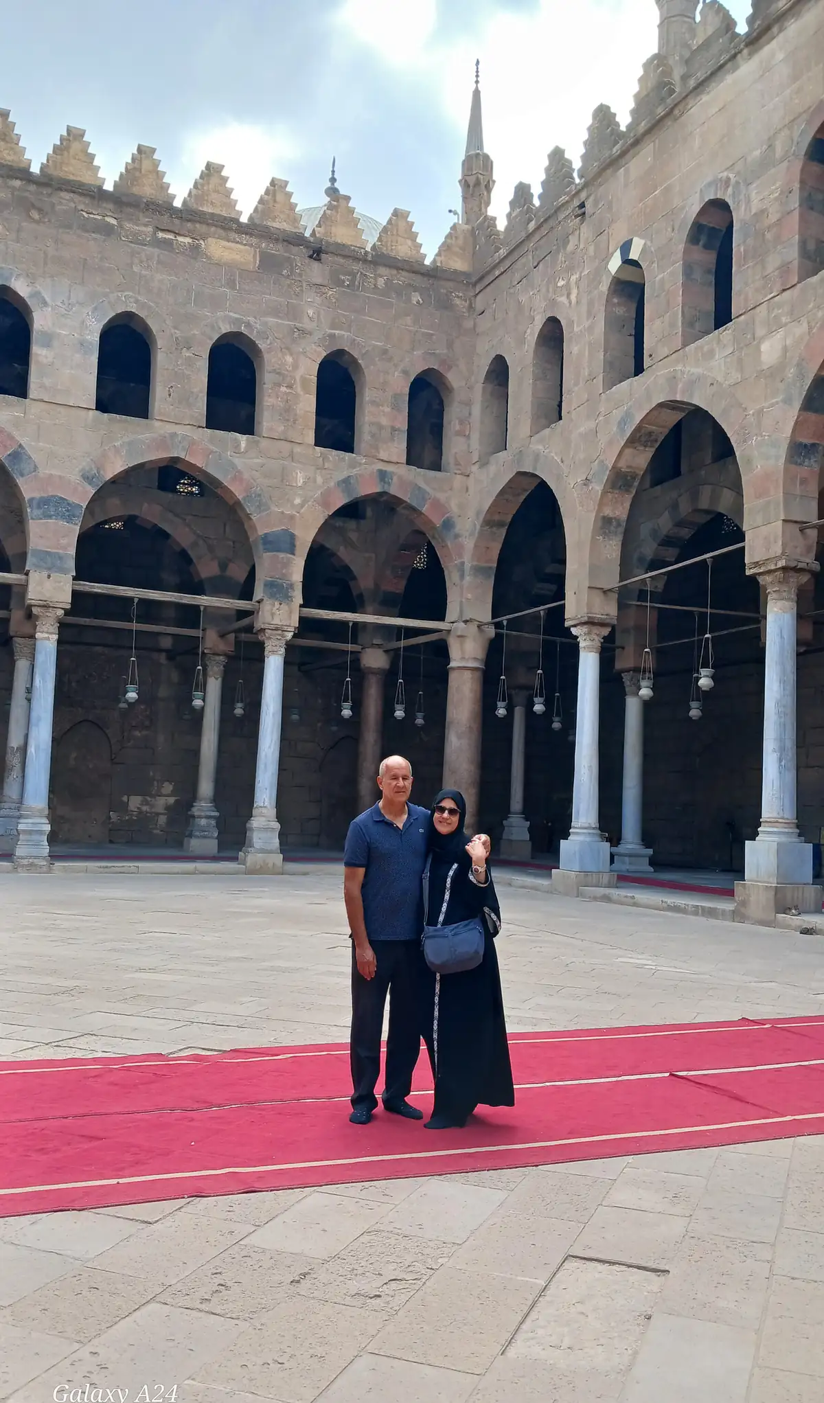 Two Travelers in the columned courtyard of a Mamluk-era Cairo mosque