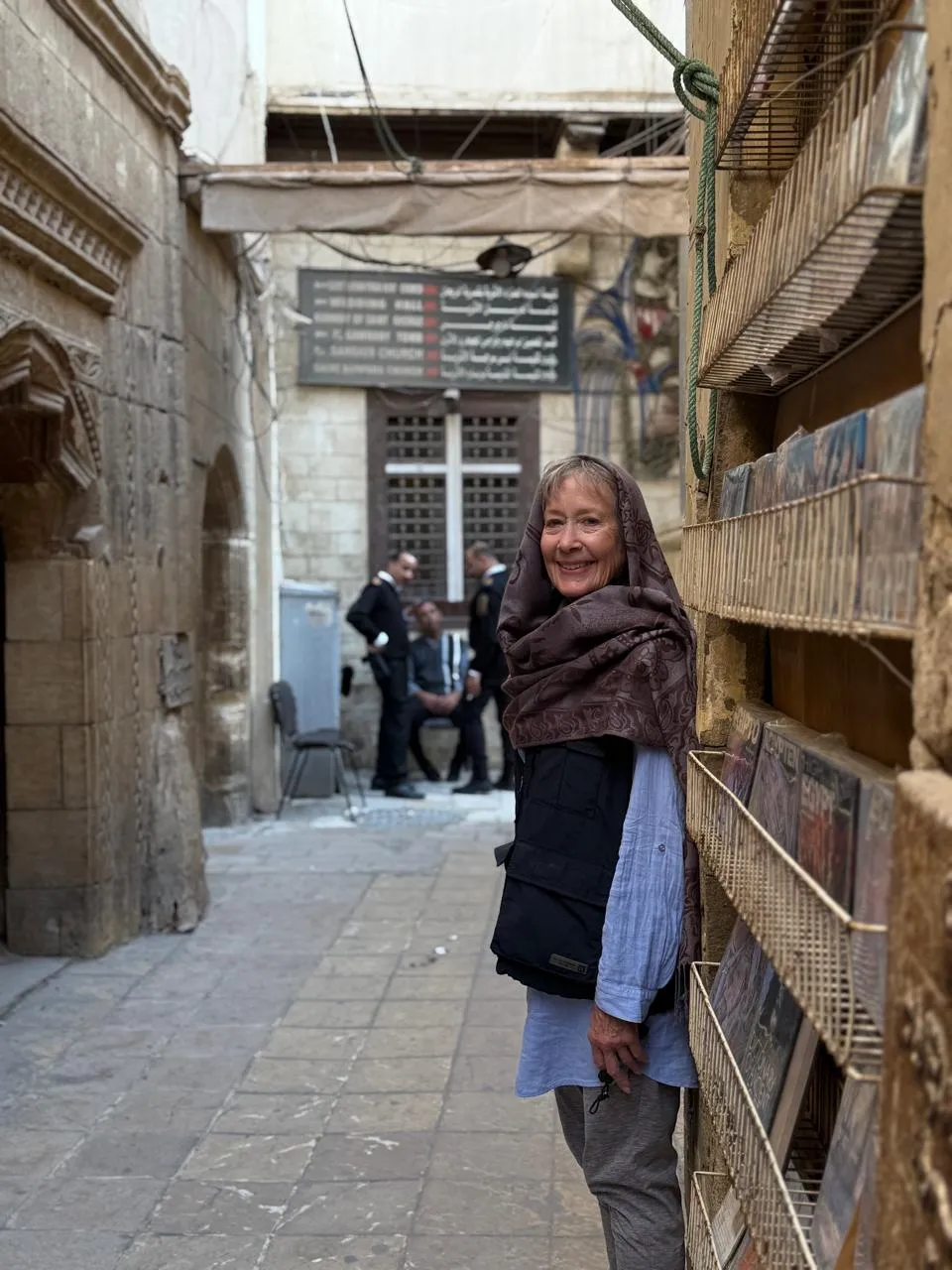 Traveler beside Coptic Cairo directional signs for the Hanging Church and museums