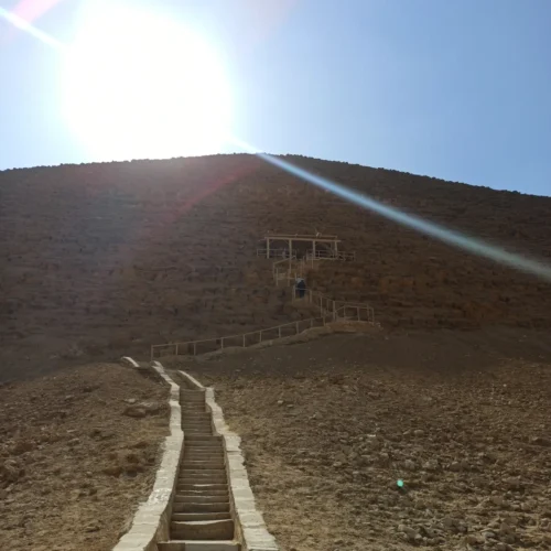 Stone stairway climbing toward the Bent Pyramid under bright sun at Dahshur