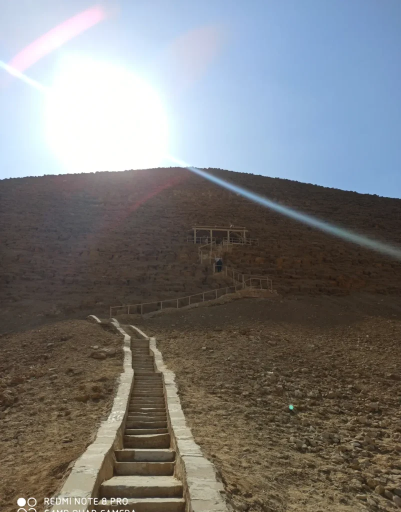 Stone stairway climbing toward the Bent Pyramid under bright sun at Dahshur