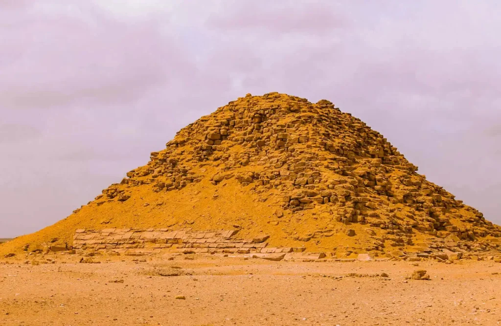 Eroded mound of an ancient pyramid rising from the desert at Dahshur