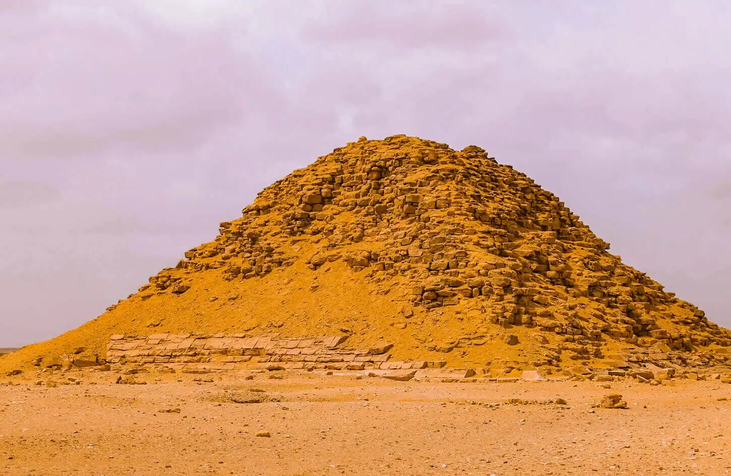 Eroded mound of an ancient pyramid rising from the desert at Dahshur