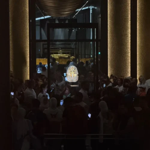 Visitors around the golden mask of Tutankhamun display at the museum