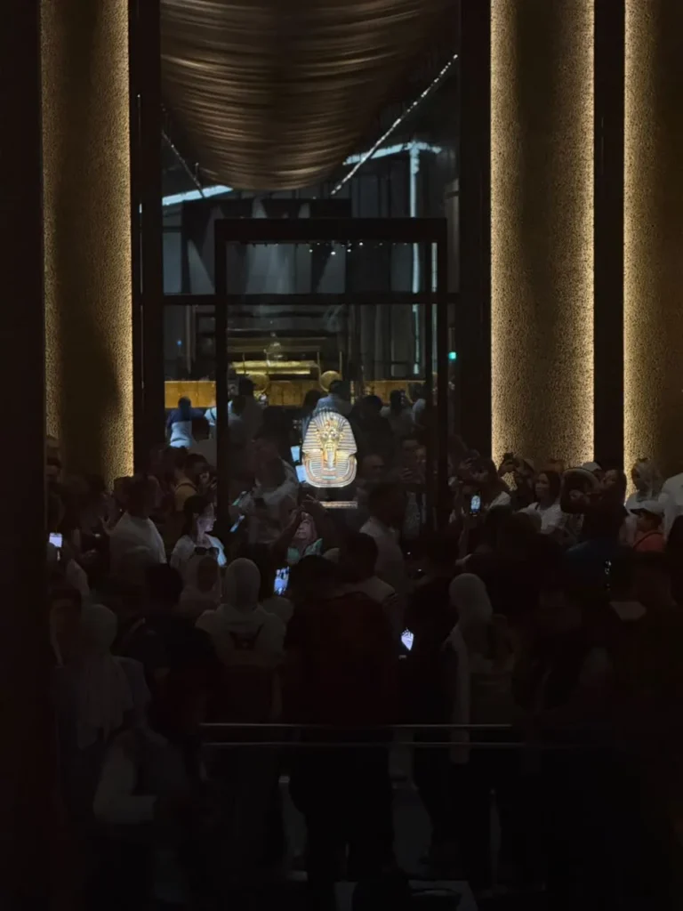 Visitors around the golden mask of Tutankhamun display at the museum