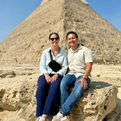 Couple seated on a rock in front of the Pyramid of Khafre at Giza