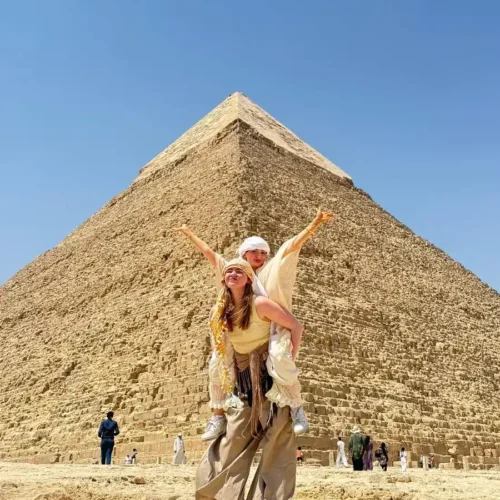 Two friends in headscarves posing in front of the Pyramid of Khafre