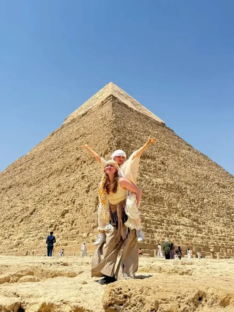 Two friends in headscarves posing in front of the Pyramid of Khafre