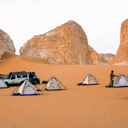 4x4 safari jeep driving across golden sand dunes in the hurghada red sea desert during a sunset safari