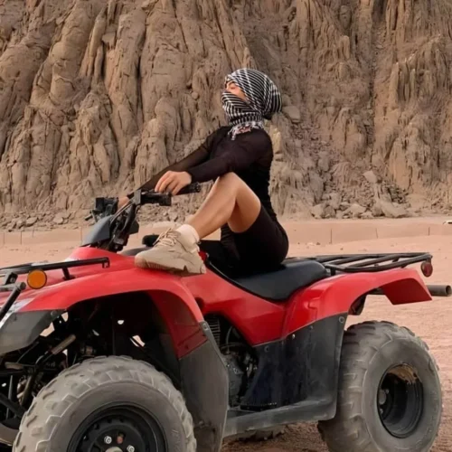 adventurous traveler riding a quad bike across red sea desert sands during a hurghada quad safari