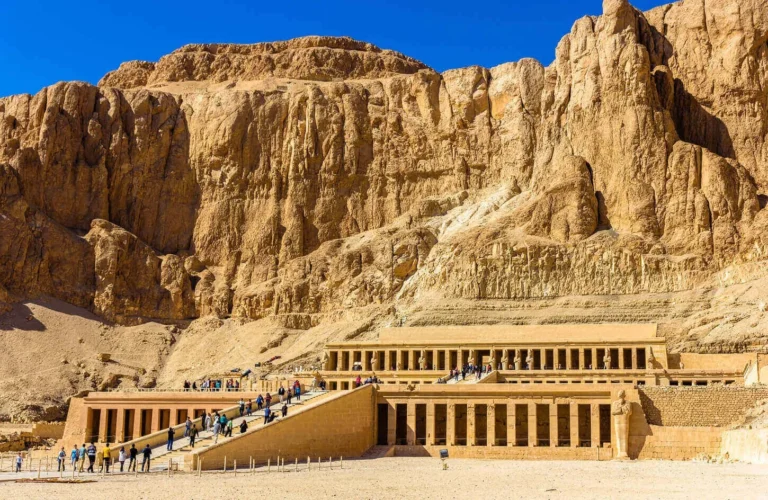 grand limestone colonnade facade of queen hatshepsut temple at the foot of the deir el-bahari cliffs