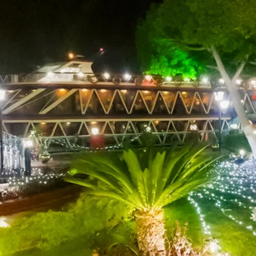 Illuminated Nile Crystal dinner cruise boat docked at night in Cairo