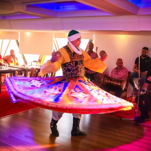 Tanoura dancer spinning a colorful skirt during a Nile dinner cruise show