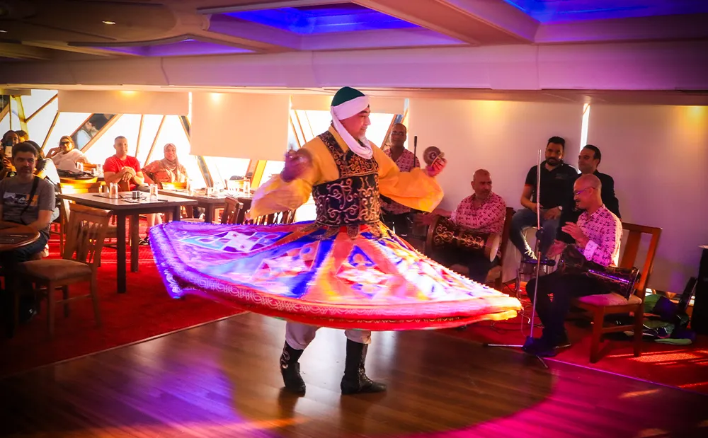 Tanoura dancer spinning a colorful skirt during a Nile dinner cruise show