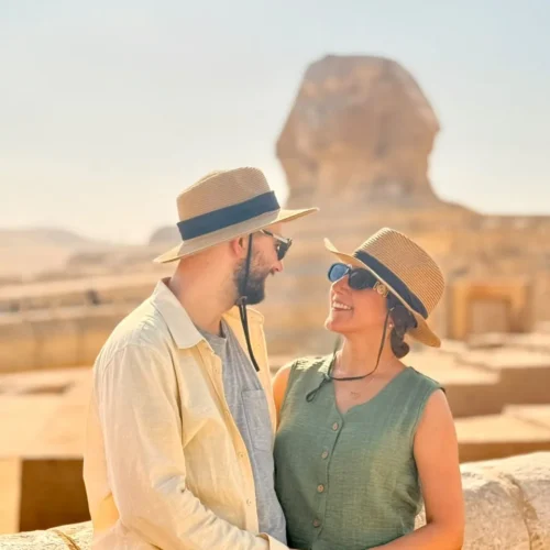 Couple in sun hats in front of the Great Sphinx of Giza
