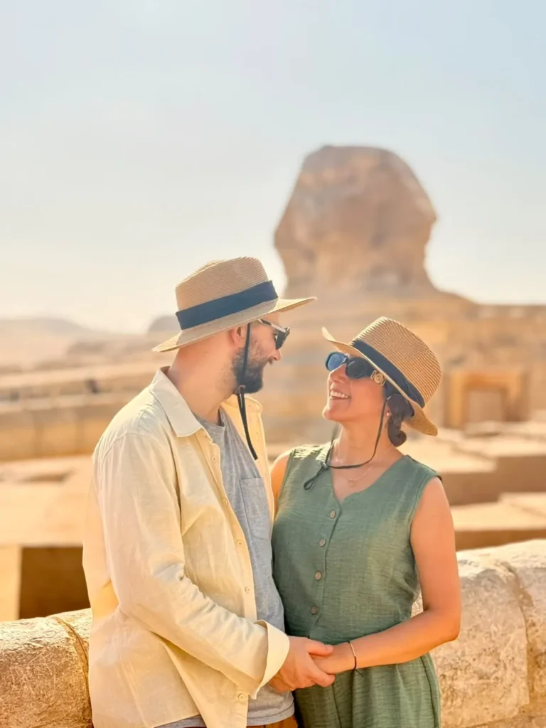 Couple in sun hats in front of the Great Sphinx of Giza