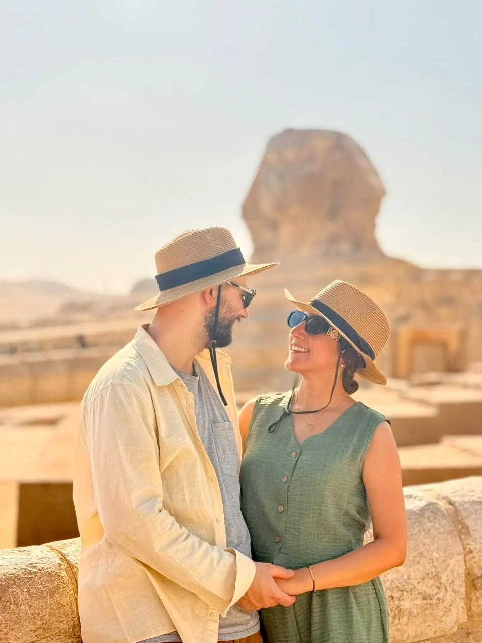 Couple in sun hats in front of the Great Sphinx of Giza