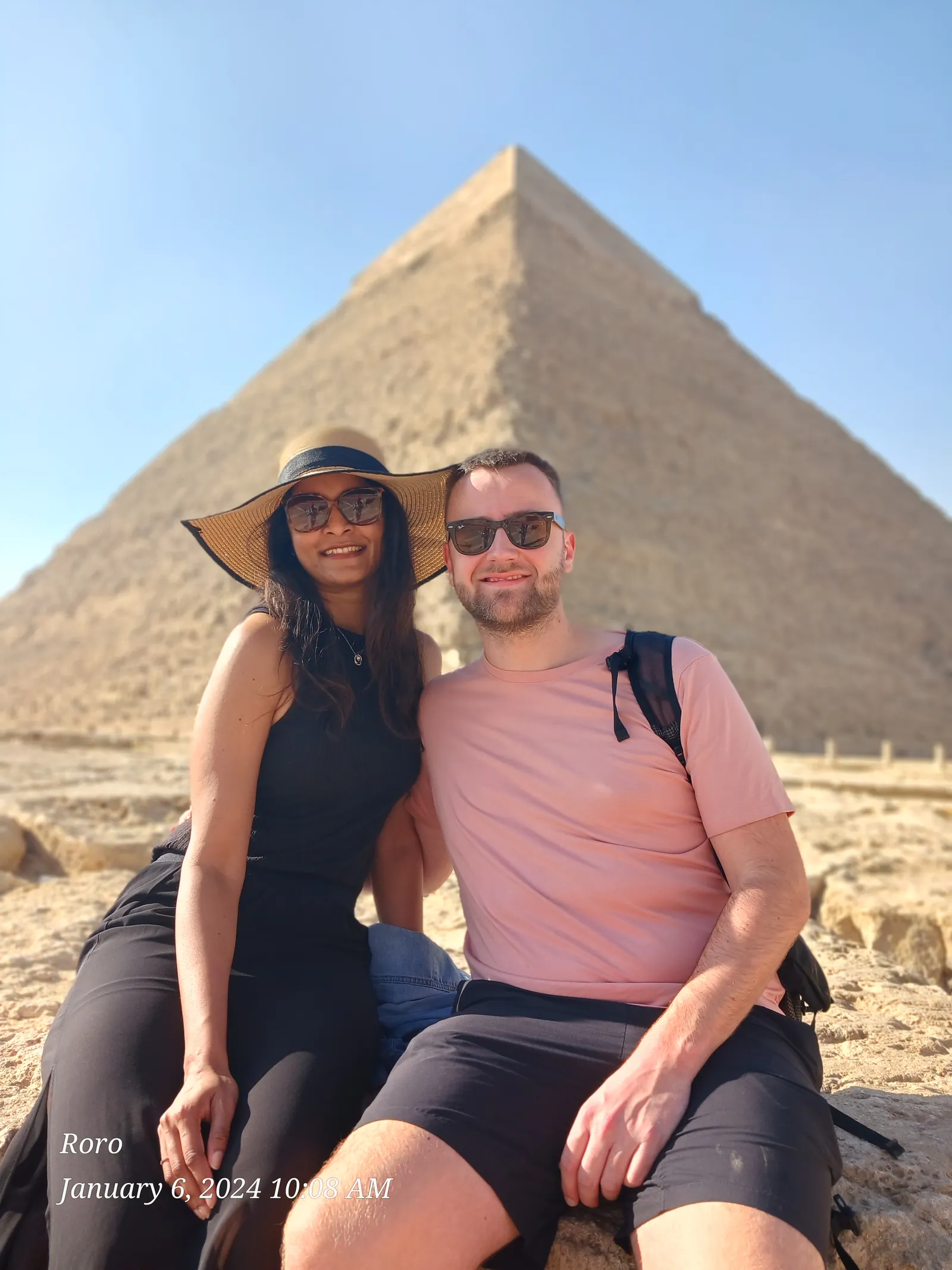 Couple seated in front of the Pyramid of Khafre at Giza