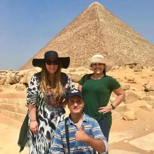 Travelers and their guide in front of the Great Pyramid of Giza
