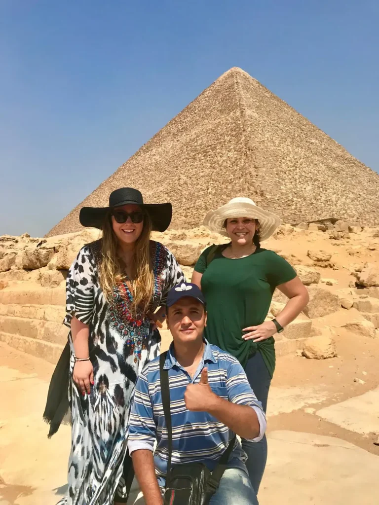 Travelers and their guide in front of the Great Pyramid of Giza