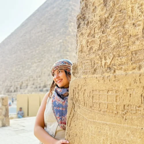 Traveler beside the massive stone blocks of the Great Pyramid