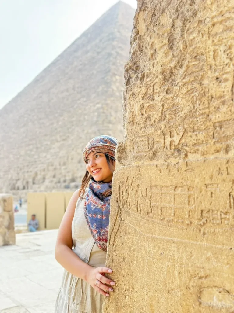 Traveler beside the massive stone blocks of the Great Pyramid