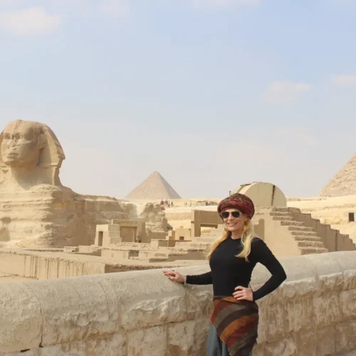 Traveler at Giza with the Great Sphinx and Pyramid of Khafre behind