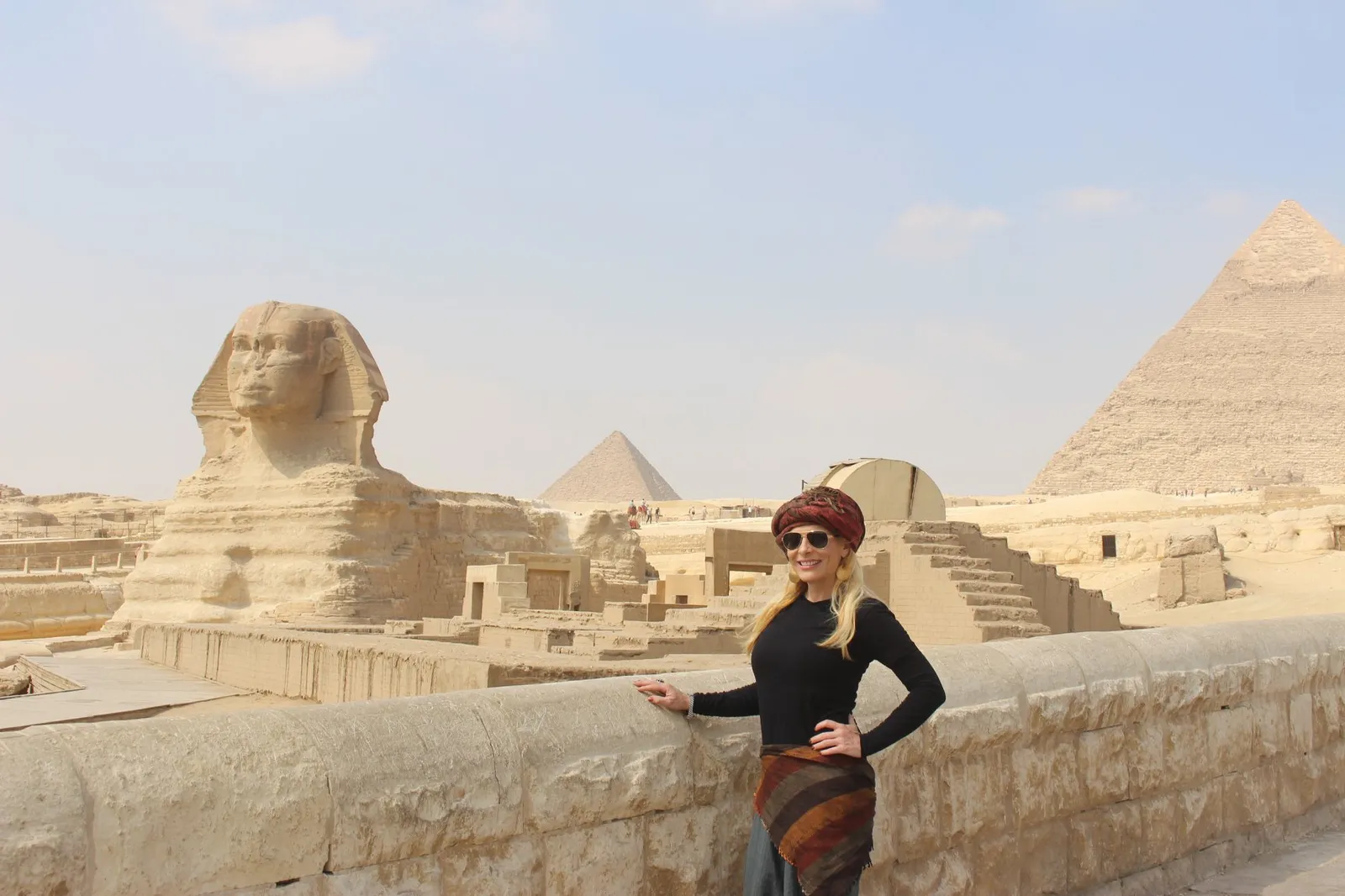 Traveler at Giza with the Great Sphinx and Pyramid of Khafre behind
