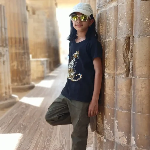 Girl leaning against the fluted columns of the Djoser entrance colonnade at Saqqara