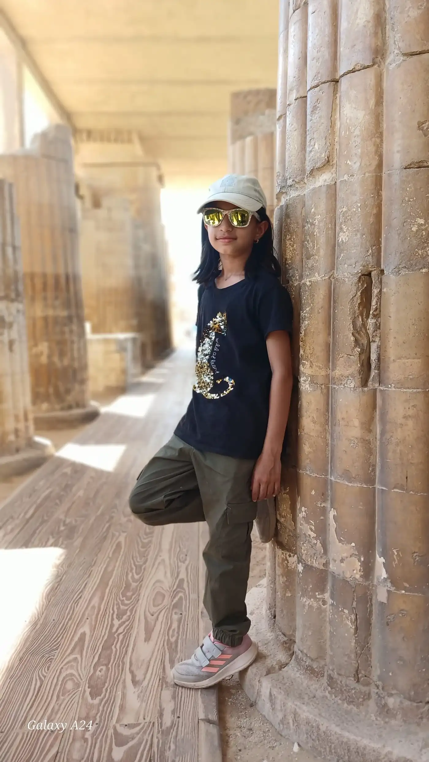 Girl leaning against the fluted columns of the Djoser entrance colonnade at Saqqara