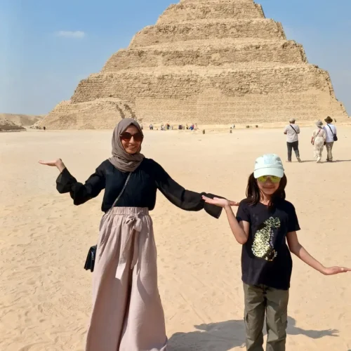 Mother and child posing in front of the Step Pyramid of Djoser at Saqqara