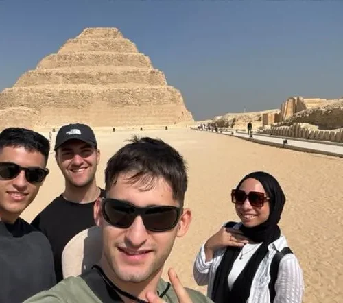 Group of friends taking a selfie on the causeway to the Step Pyramid at Saqqara