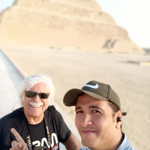 Two men taking a selfie in front of the Step Pyramid of Djoser at Saqqara