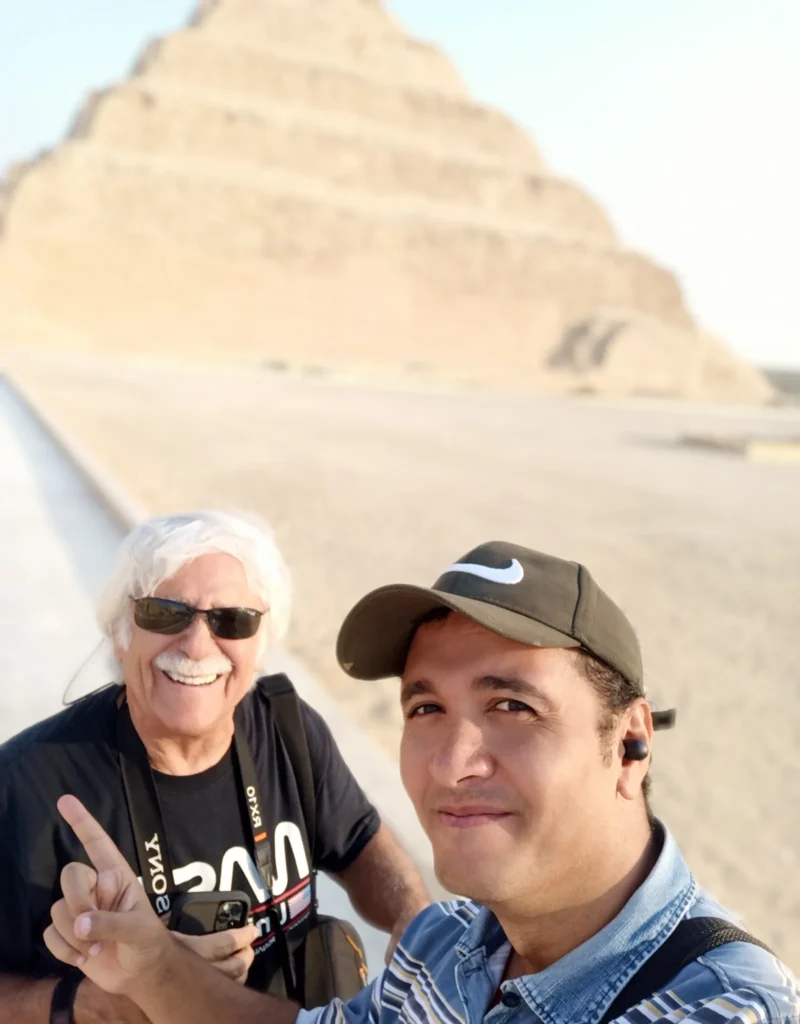 Two men taking a selfie in front of the Step Pyramid of Djoser at Saqqara
