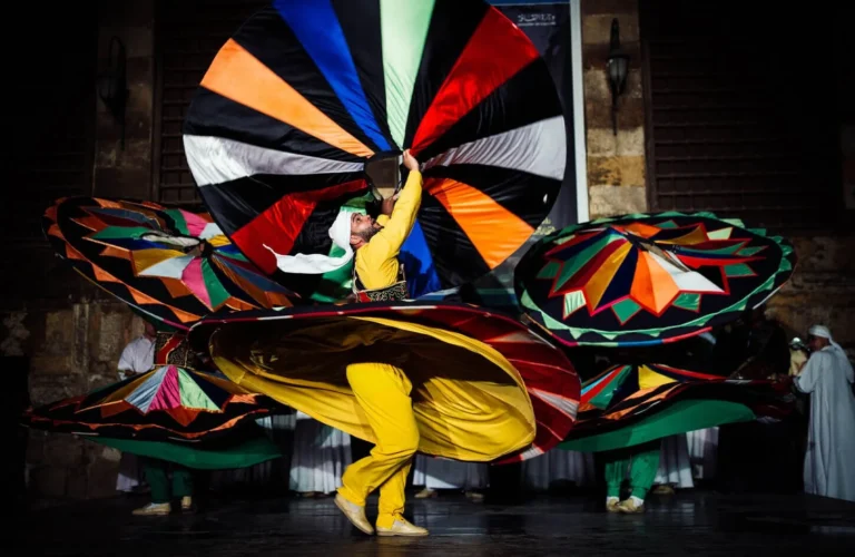 whirling dervish dancer wearing a colorful spinning skirt performing traditional tanoura sufi dance at wekalet el ghouri cairo