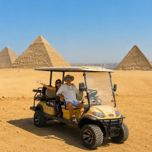 Couple in a private golf cart with all the Giza pyramids behind them
