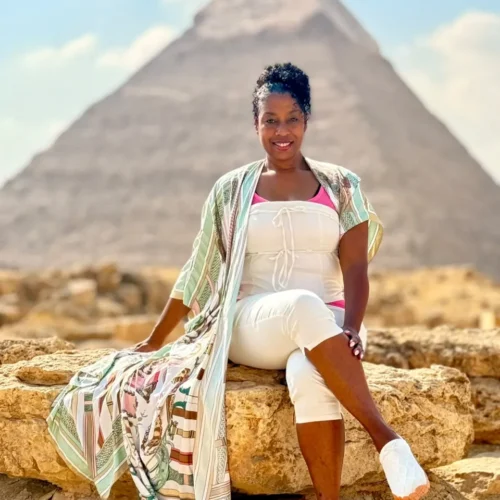 Traveler seated on rocks in front of the Pyramid of Khafre at Giza