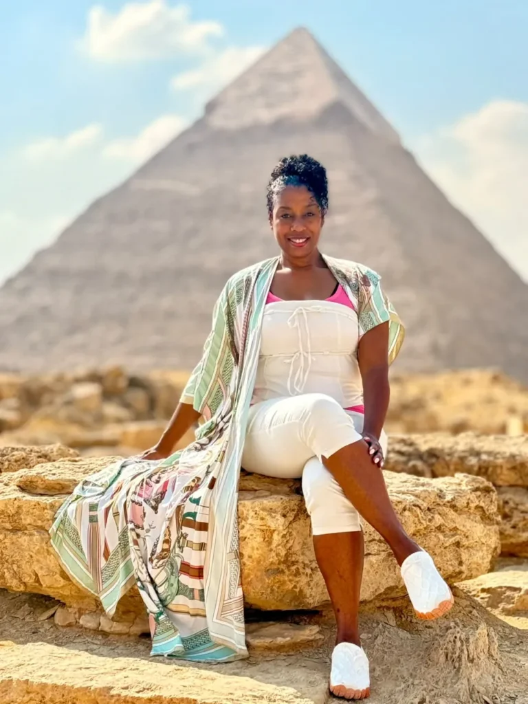 Traveler seated on rocks in front of the Pyramid of Khafre at Giza