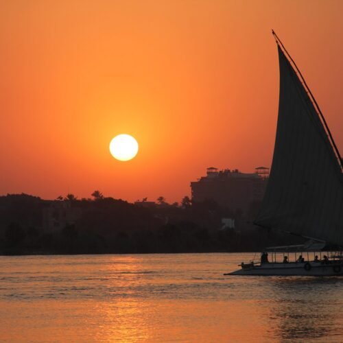 The sunsets in cairo and the sail boat is alone in the area. Only acompanied by the beautiful colors of the sky and water.