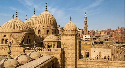 Close view of carved Mamluk stone domes with crescent finials above Cairo’s Northern Cemetery