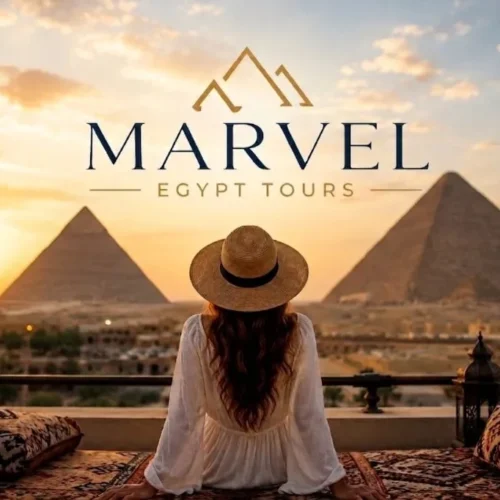 Traveler in a straw hat seated on a terrace overlooking two Giza pyramids at warm sunrise light