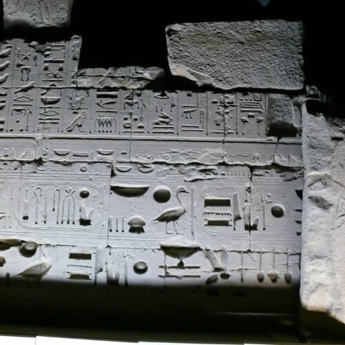 Wall with hieroglyphic texts in Karnak temple of Amun-Ra, Egypt, at night.
