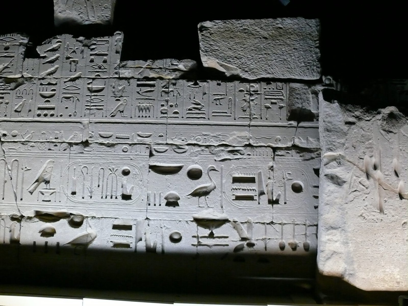 Wall with hieroglyphic texts in Karnak temple of Amun-Ra, Egypt, at night.