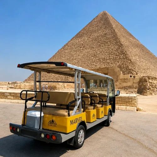 Marvel yellow golf cart parked in front of the Great Pyramid of Giza