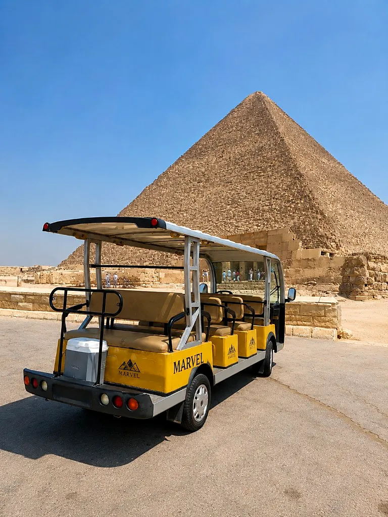 Marvel yellow golf cart parked in front of the Great Pyramid of Giza