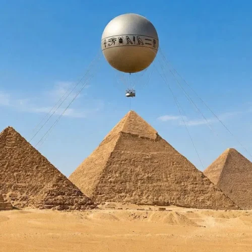 Spherical tethered balloon with a hieroglyph band hovering above the three Giza pyramids