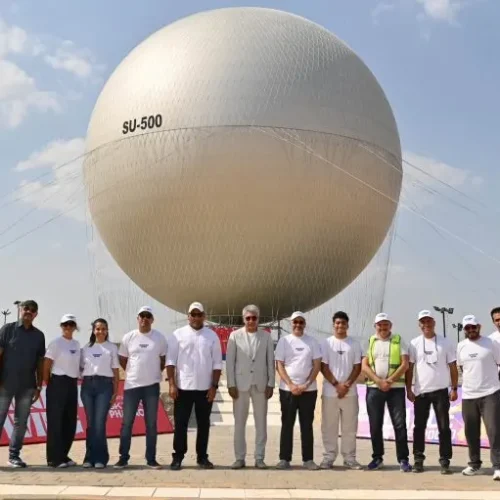 Ground team standing in front of the large SU-500 tethered balloon sphere